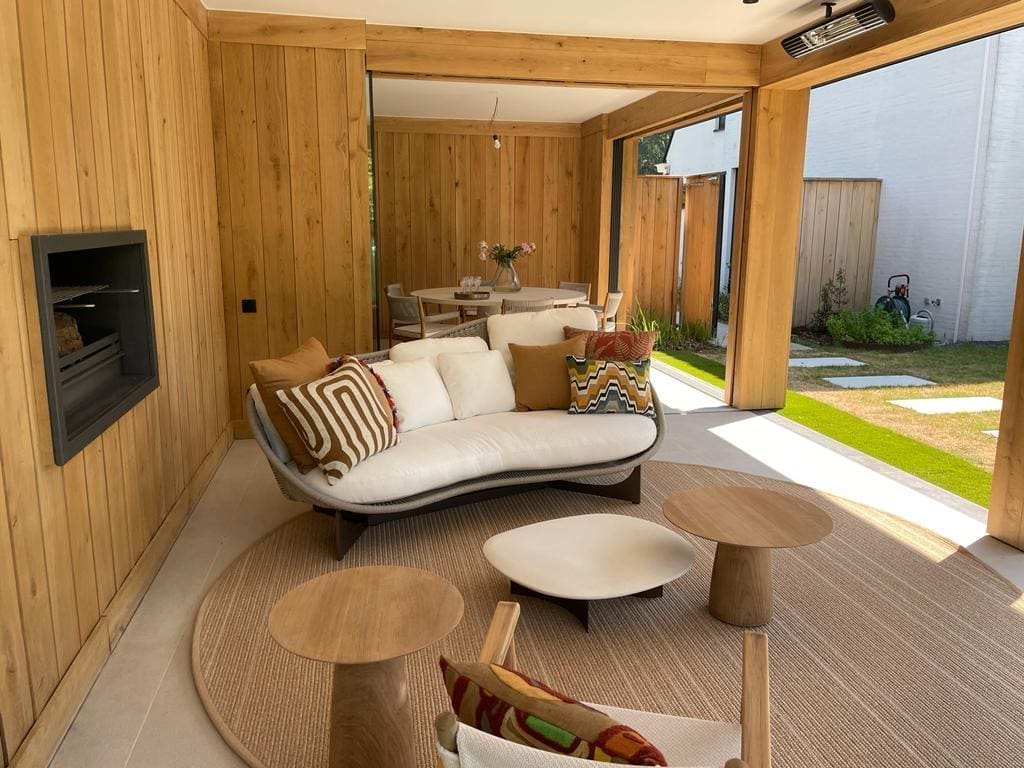 Customer project: living area clad in timber with a sofa and large window wall